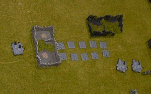 The Imperials and Tyranids face off across the ruined town